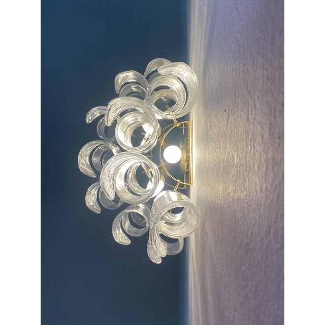 A pair of transparent “ricci” murano glass wall sconces