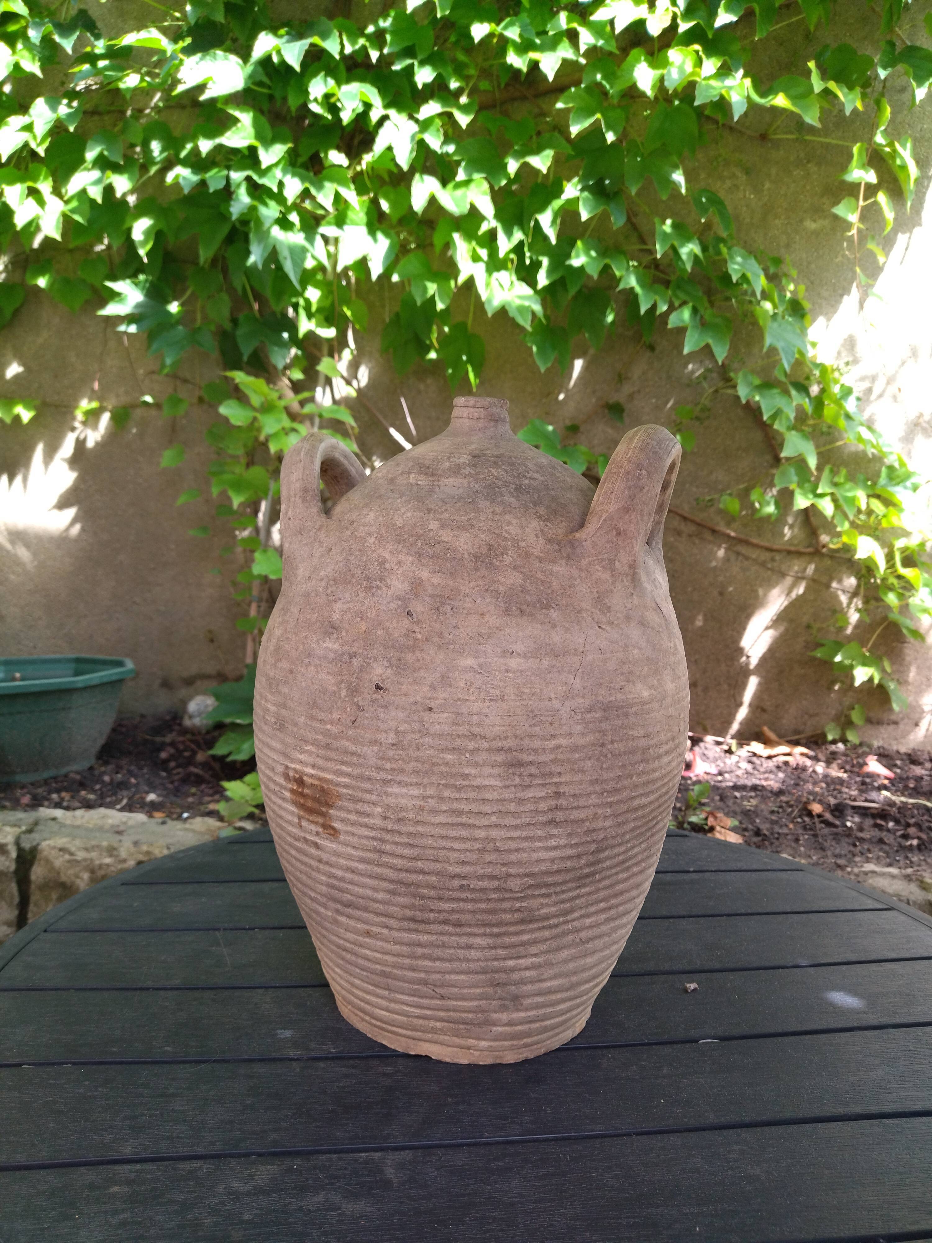 Ancient sandstone jar with two handles