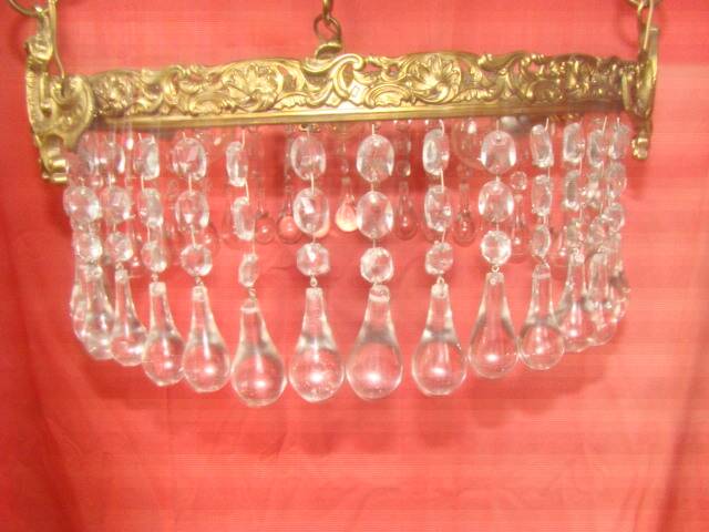 circular chandelier with a brass frame equipped with crystal drops