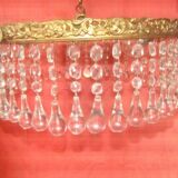 circular chandelier with a brass frame equipped with crystal drops
