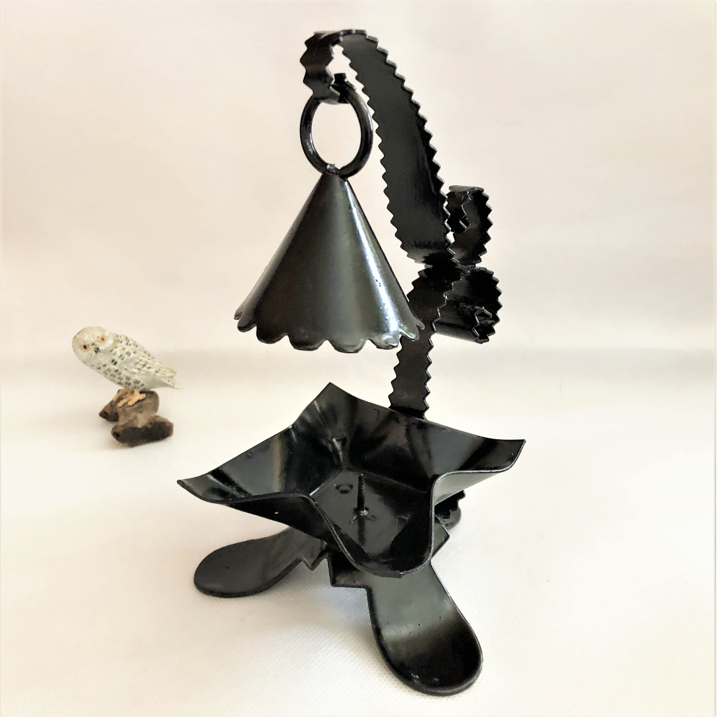 Handcrafted black wrought iron candle holder with its vintage extinguisher