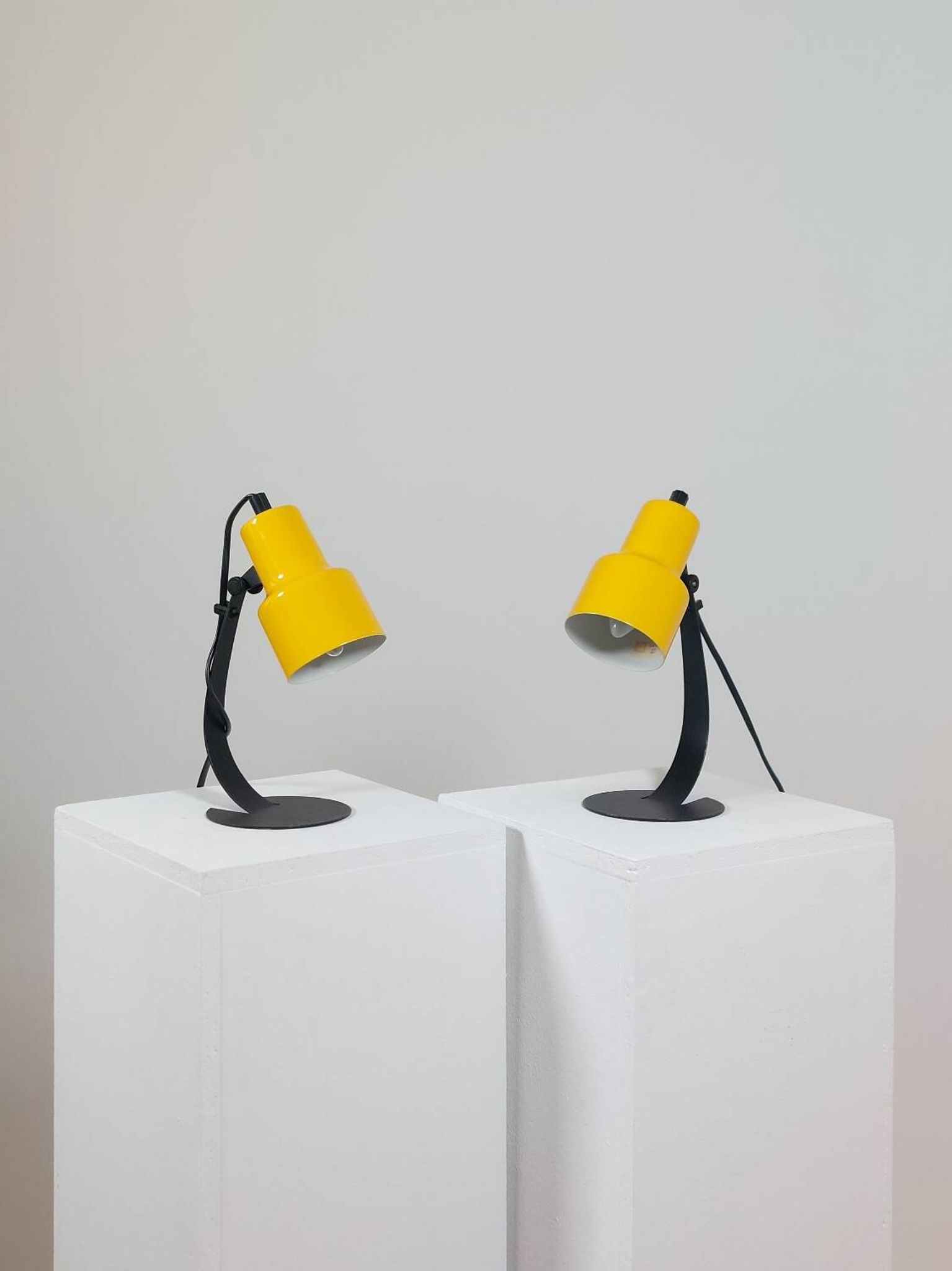 A pair of well-designed minimalist bedside lamps.