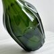 Translucent green glass bottle, classic design.