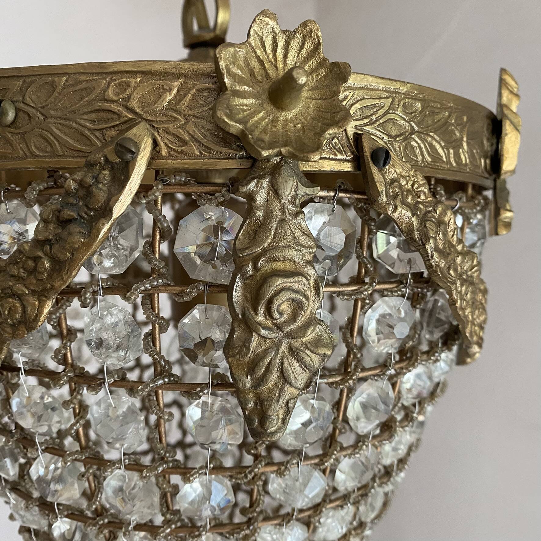 Brass basket chandelier with Louis XVI style pendants.
