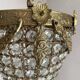 Brass basket chandelier with Louis XVI style pendants.