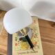 Pair of wall sconces with brass torch and white glass globe.