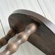 Three-legged demi-lune stool made of turned wood