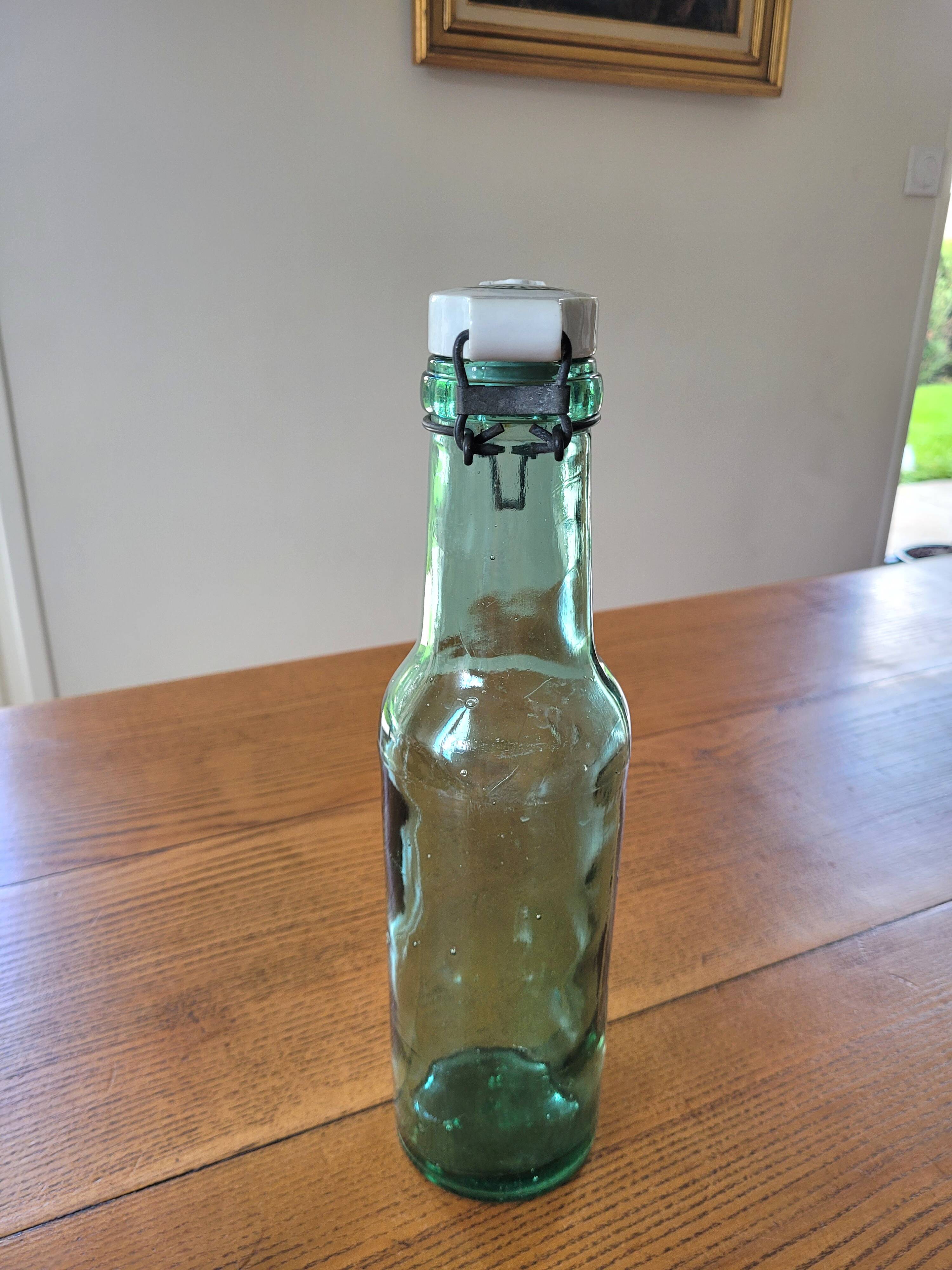 Vintage glass bottle l'Idéale with porcelain stopper