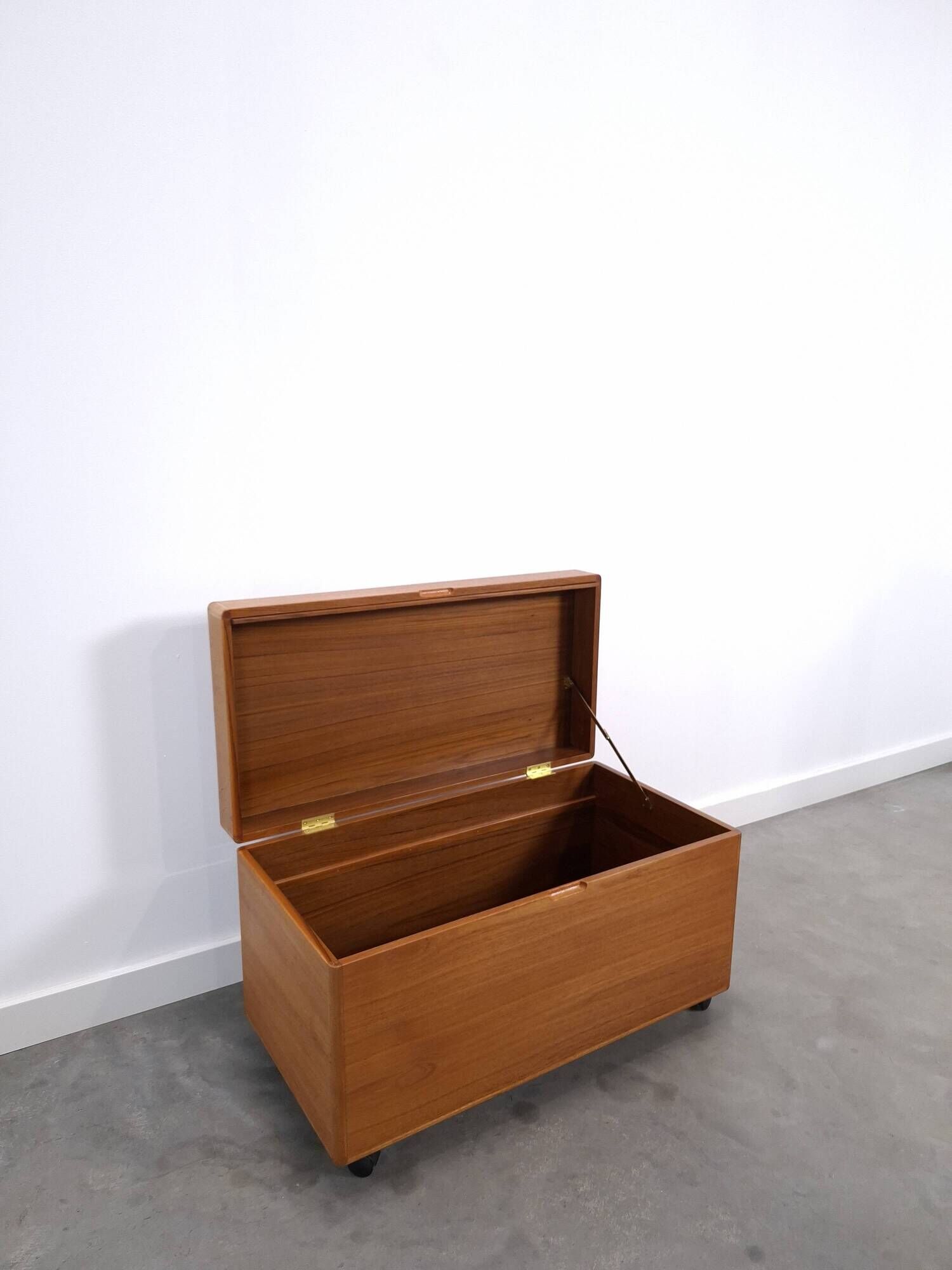 Vintage teak Danish chest with a lid on wheels, toy chest.