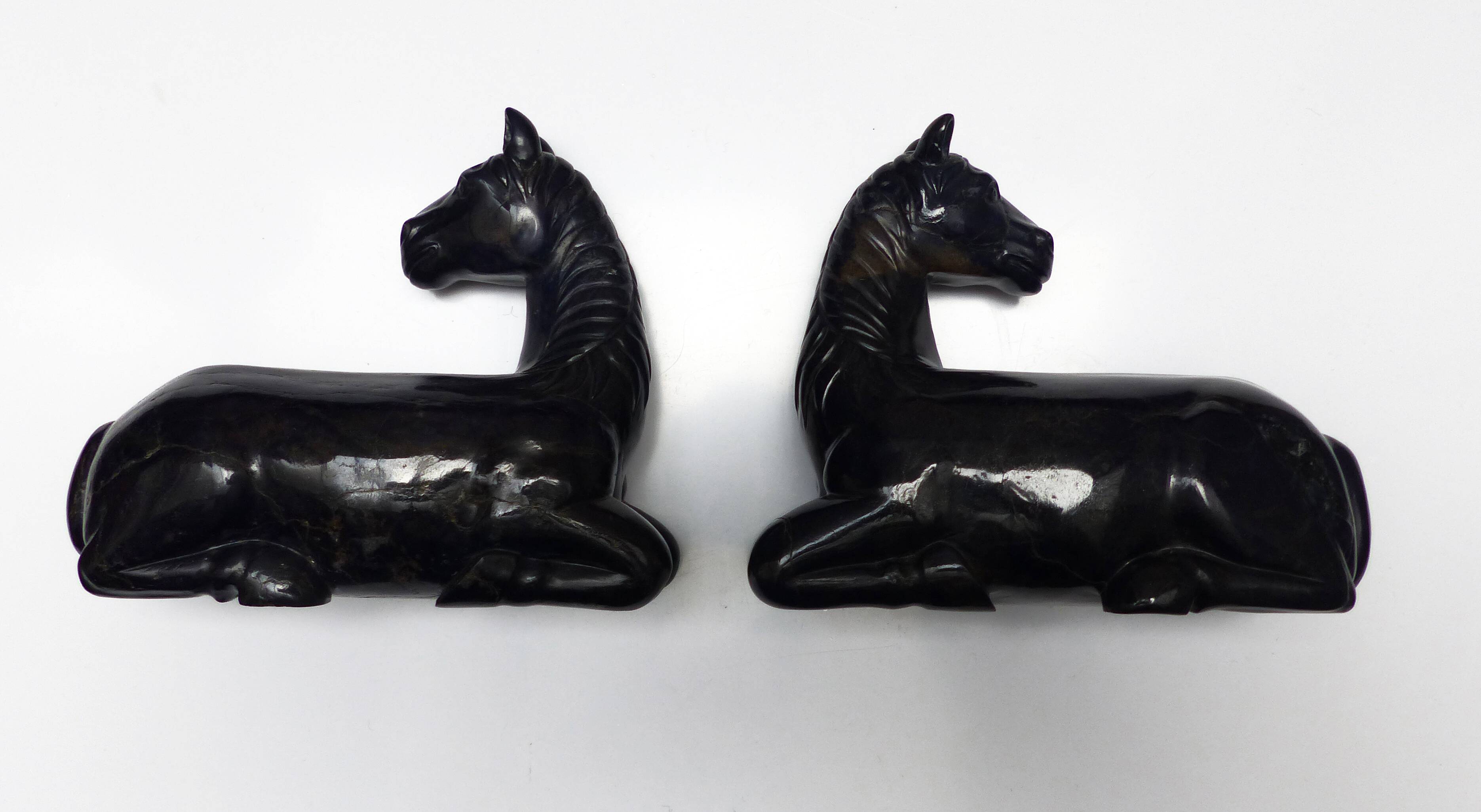 Black marble bookends with lying horses