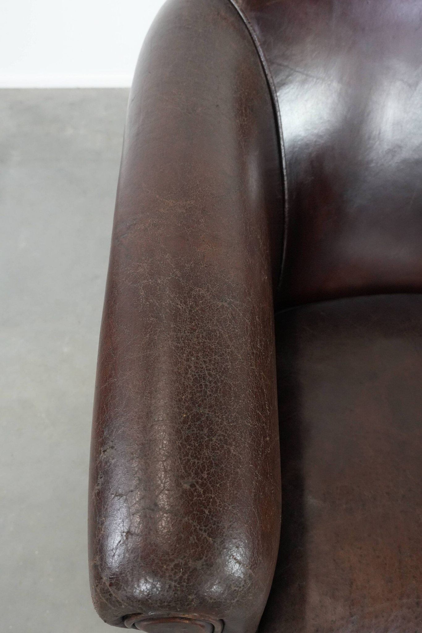 Stylish and sturdy dark brown club armchair made of sheepskin leather