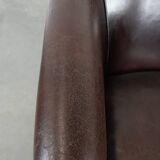 Stylish and sturdy dark brown club armchair made of sheepskin leather