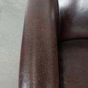 Stylish and sturdy dark brown club armchair made of sheepskin leather