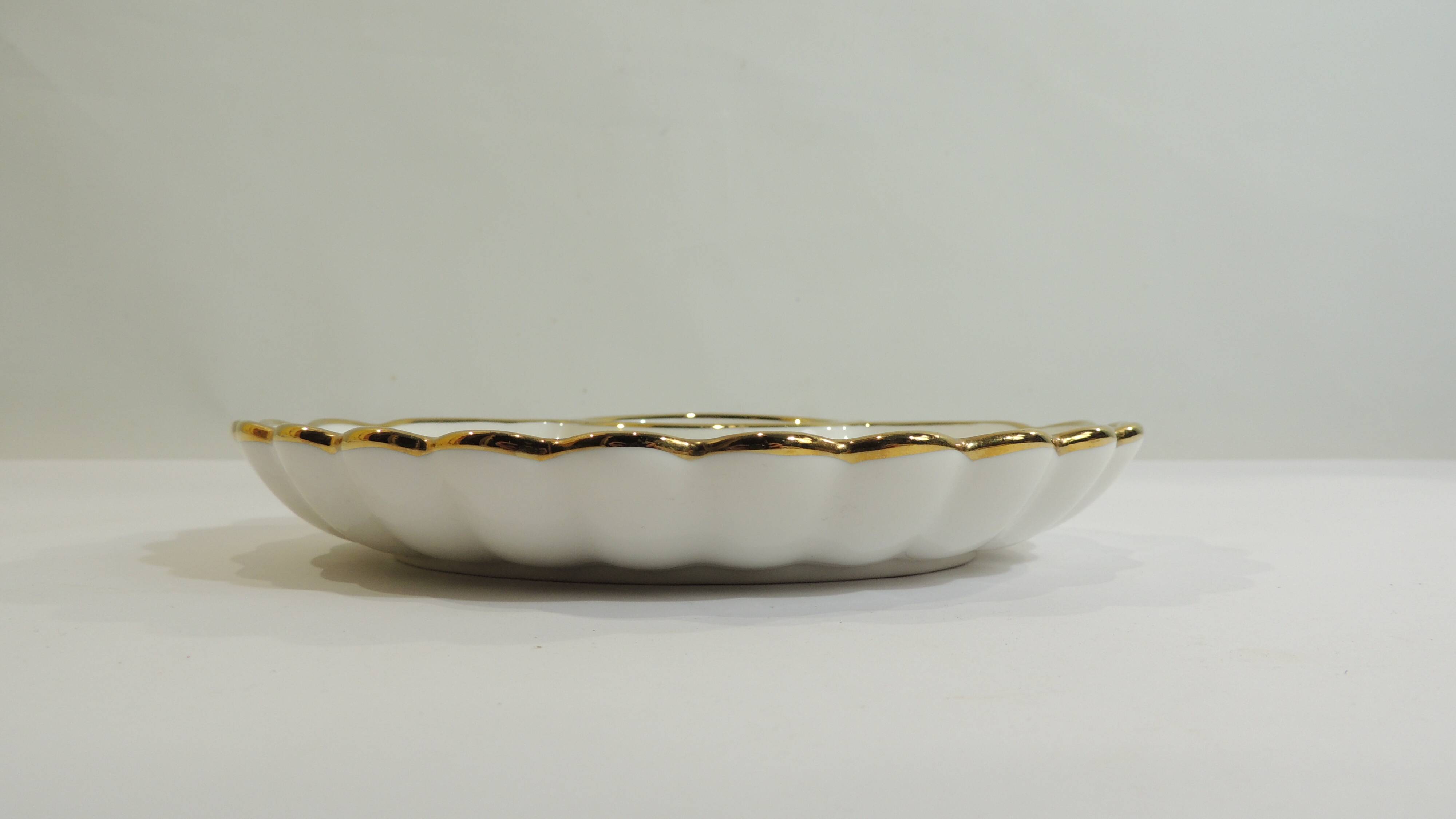 Shell-shaped porcelain pocket bowl from Queen’s Porcelain, with a gold rim.