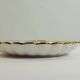 Shell-shaped porcelain pocket bowl from Queen’s Porcelain, with a gold rim.