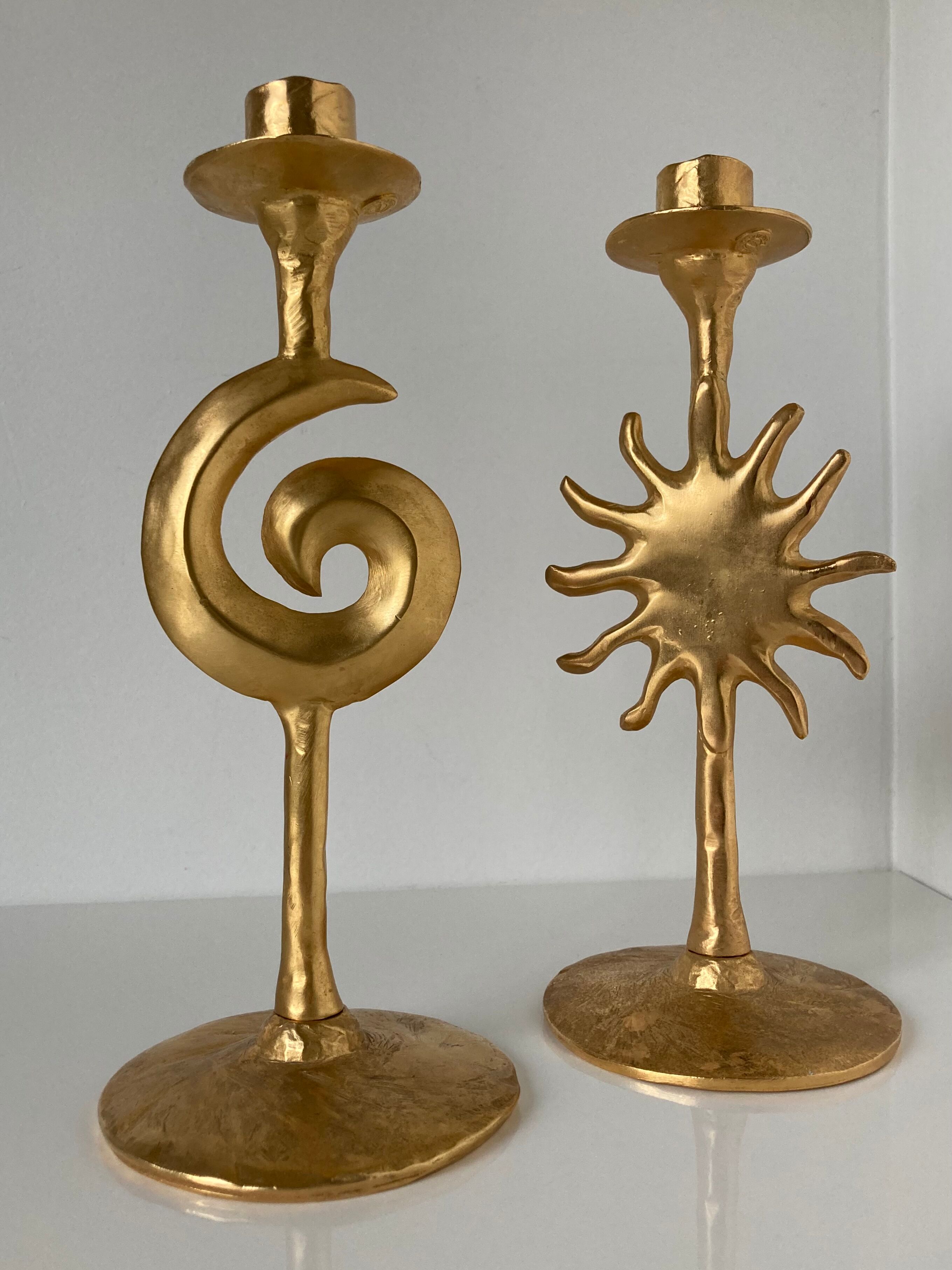Paire de bougeoirs lune et soleil en métal doré par Édouard Rambaud