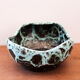 Empty pocket in black ceramic with green drip