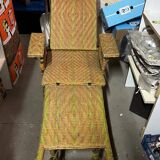 Old long chair rattan wicker garden armchair
