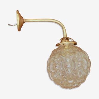Gold metal and glass globe sconce