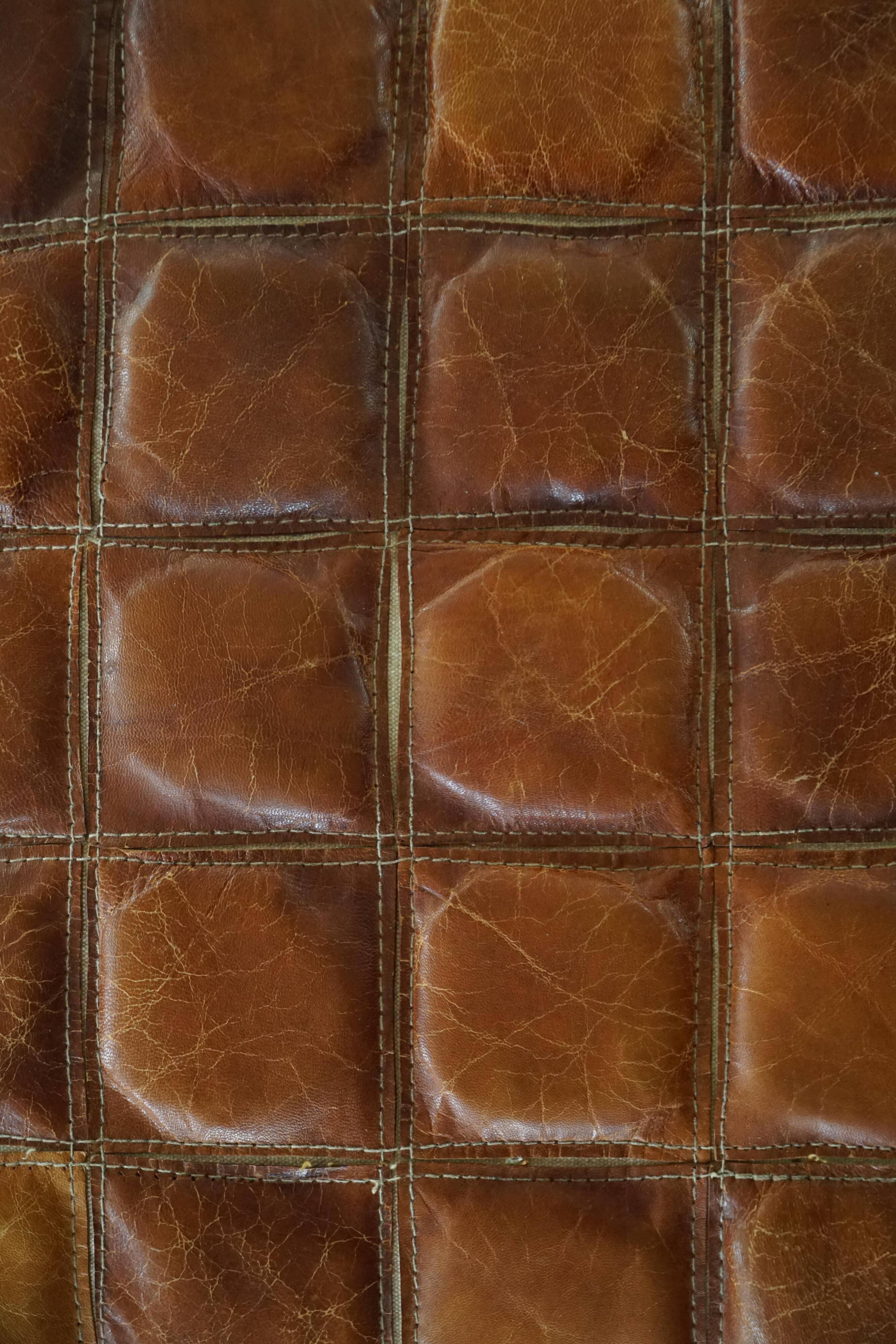 Mid-20th century pouf / ottoman cube in patinated brown leather, 1960s.
