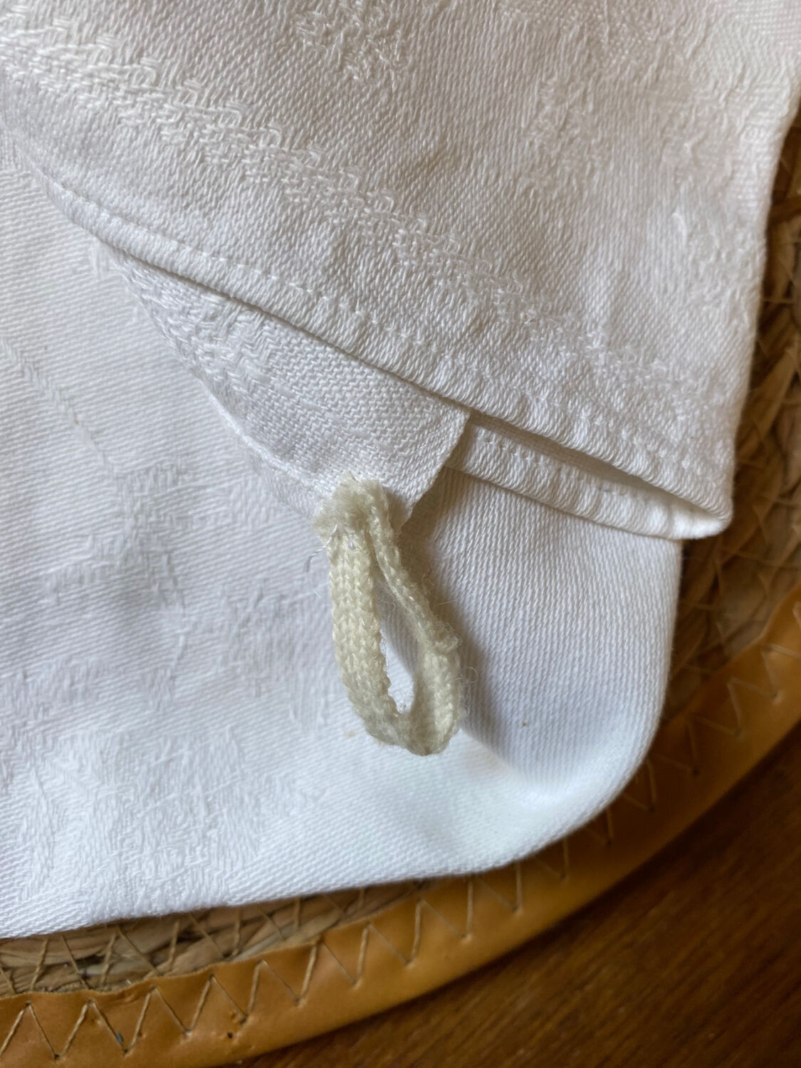 Pair of embroidered white cotton tea towels.