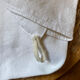 Pair of embroidered white cotton tea towels.