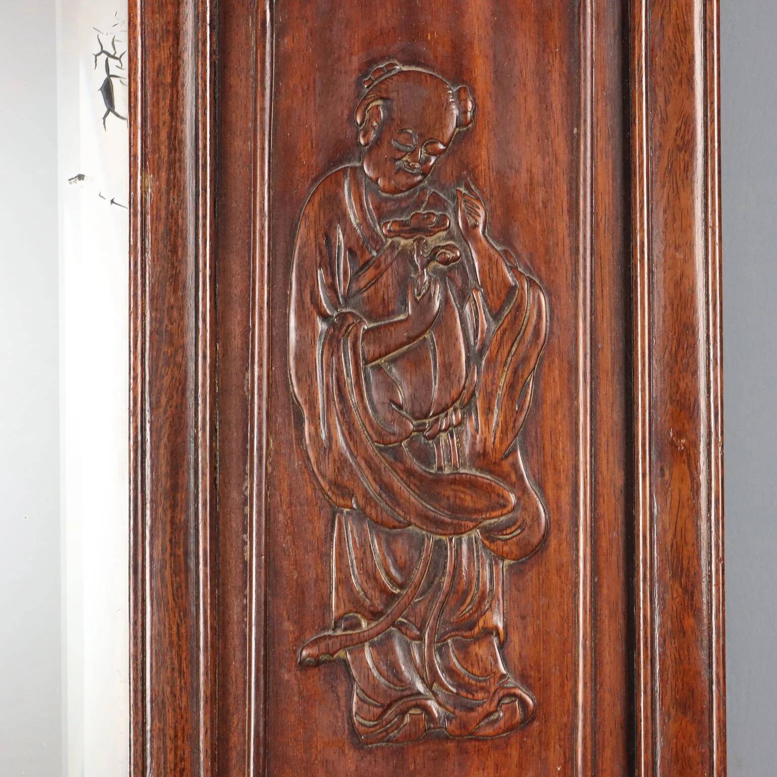Antique mirror in exotic wood with chinoiserie carvings, 19th century.