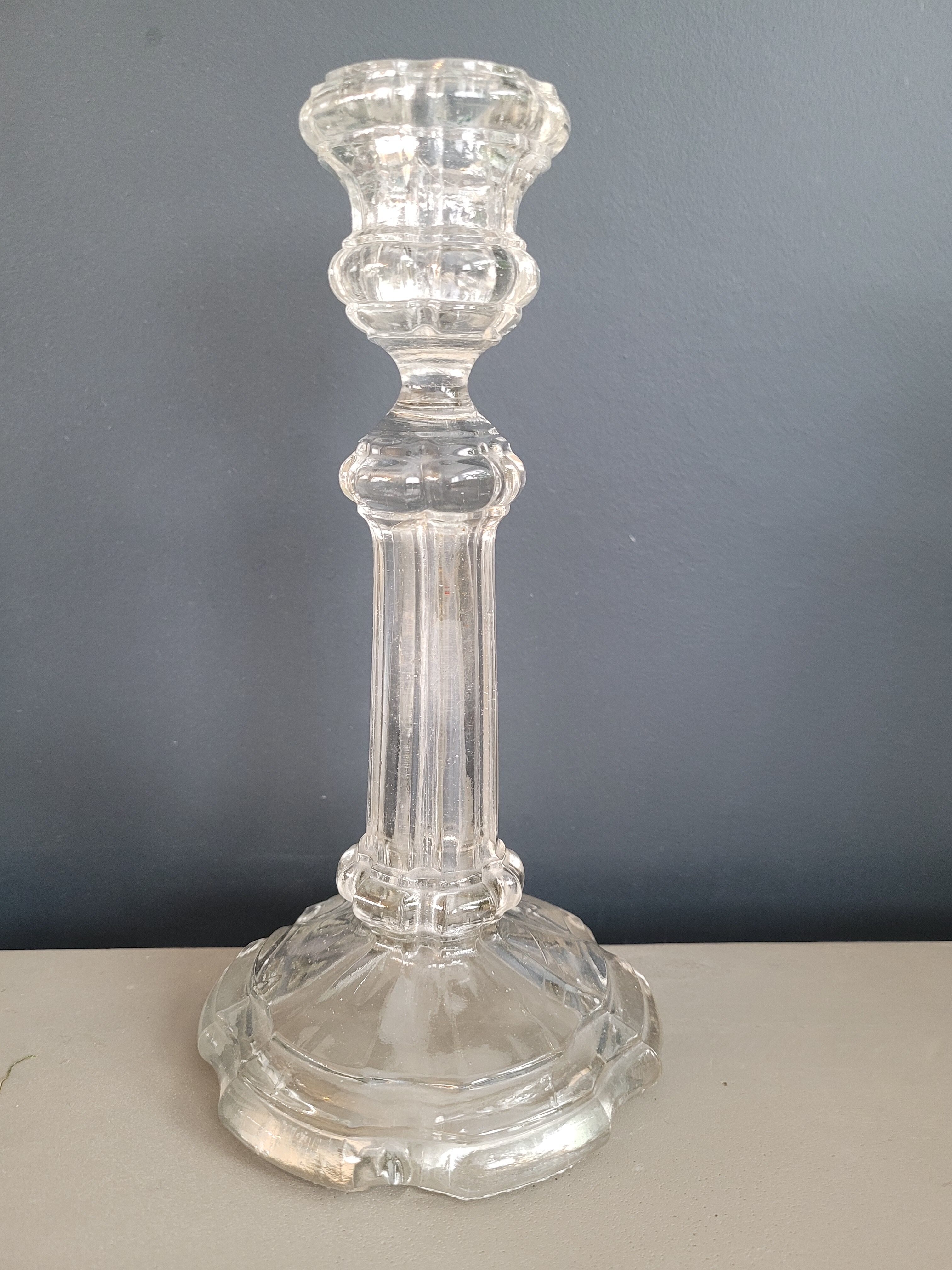 Old candlestick with molded glass stamps