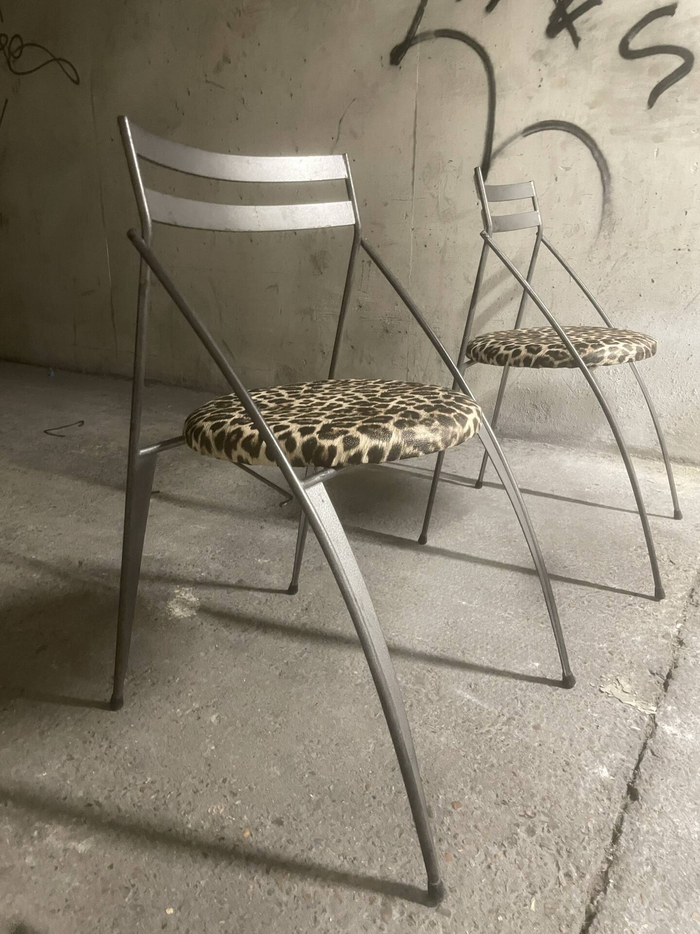 Pair of folding chairs from the 80s with leopard print seats.