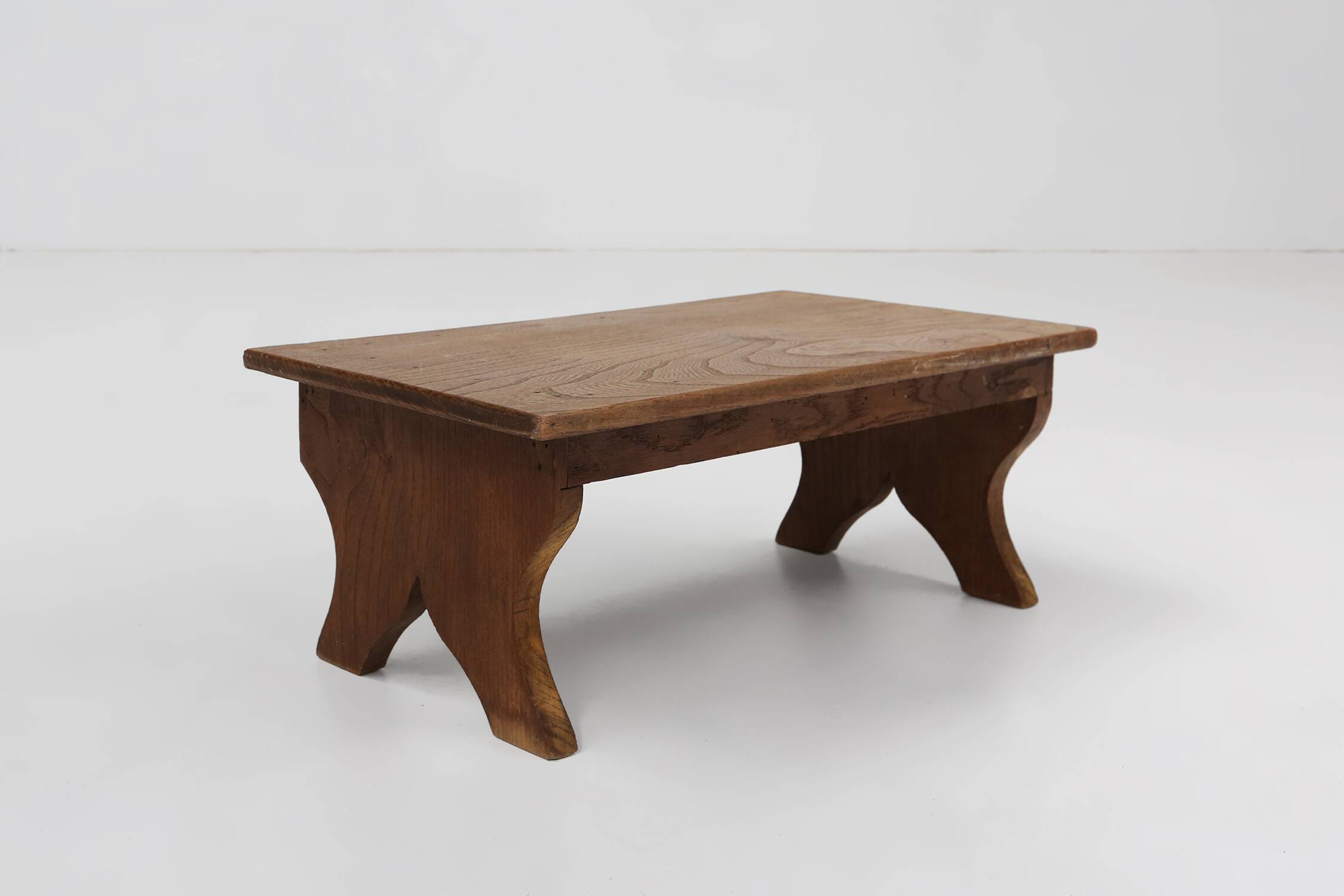 Small rustic wooden stool with curved base, France ca. 1900