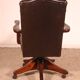 Office chair known as a director's chair in wood and tufted leather.
