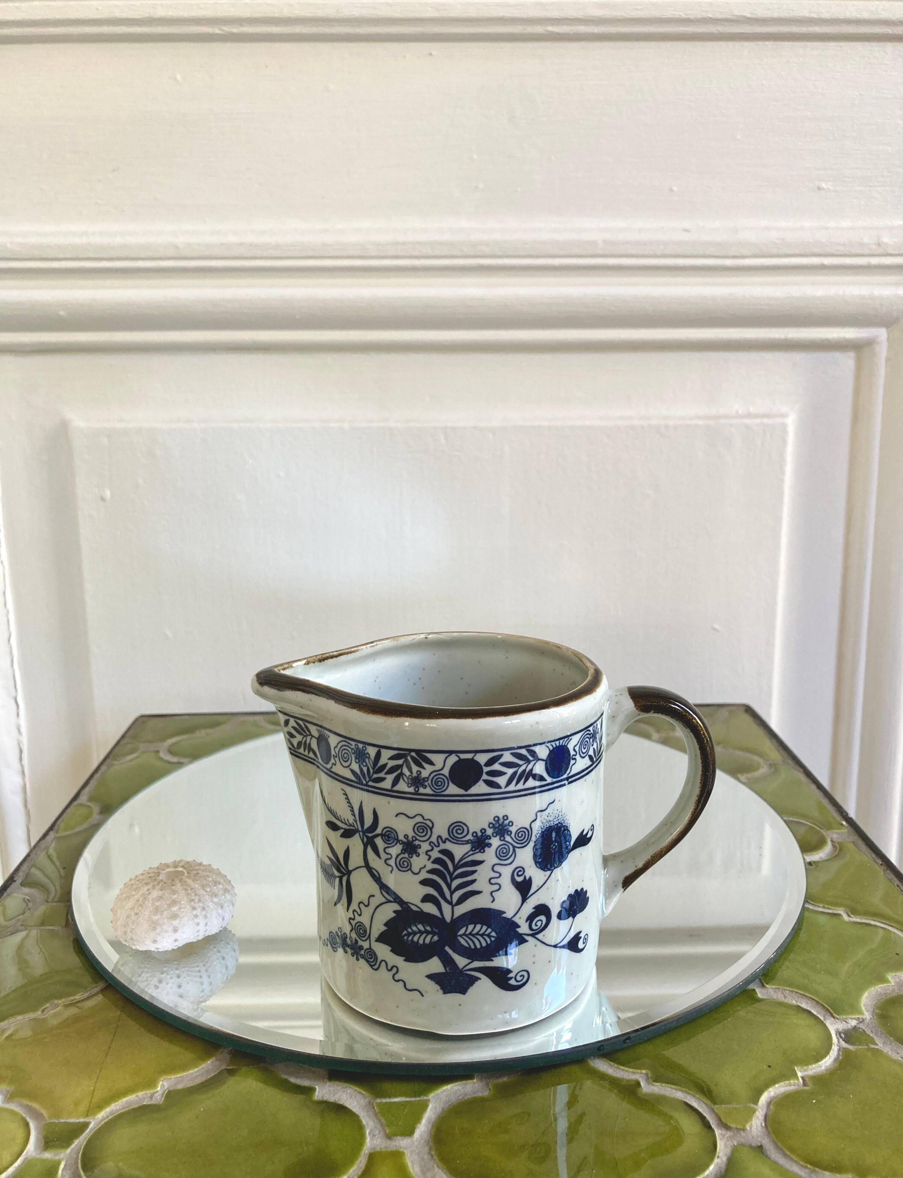 Stoneware milk jug with flower decoration