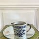 Stoneware milk jug with flower decoration