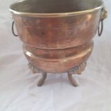 Hammered copper planter cover, lion's head handles and feet
