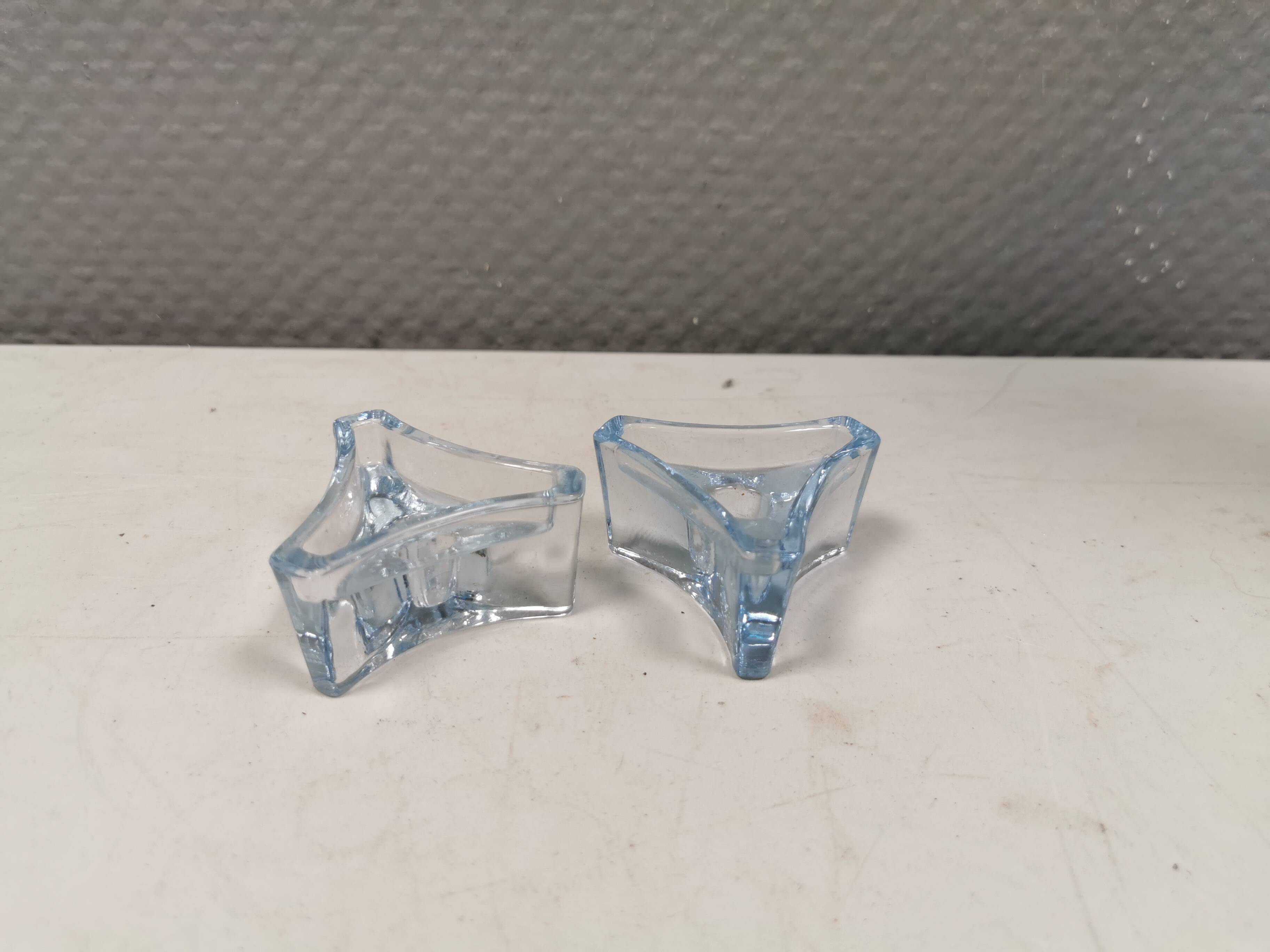 Two beautiful glass candle holders in translucent bluish glass.