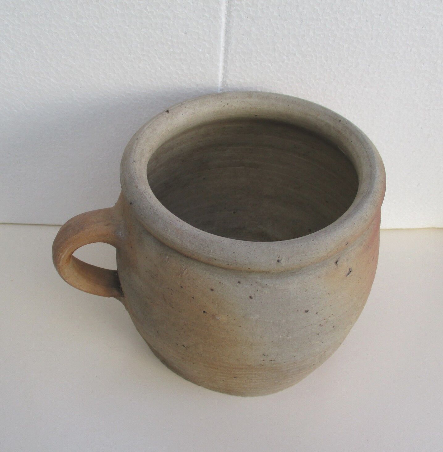 Ancient sandstone pot at one handle