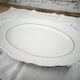 Oval porcelain plate with double gold line, hand-painted.