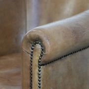 Characterful club chair made of sheepskin leather with light cognac colours