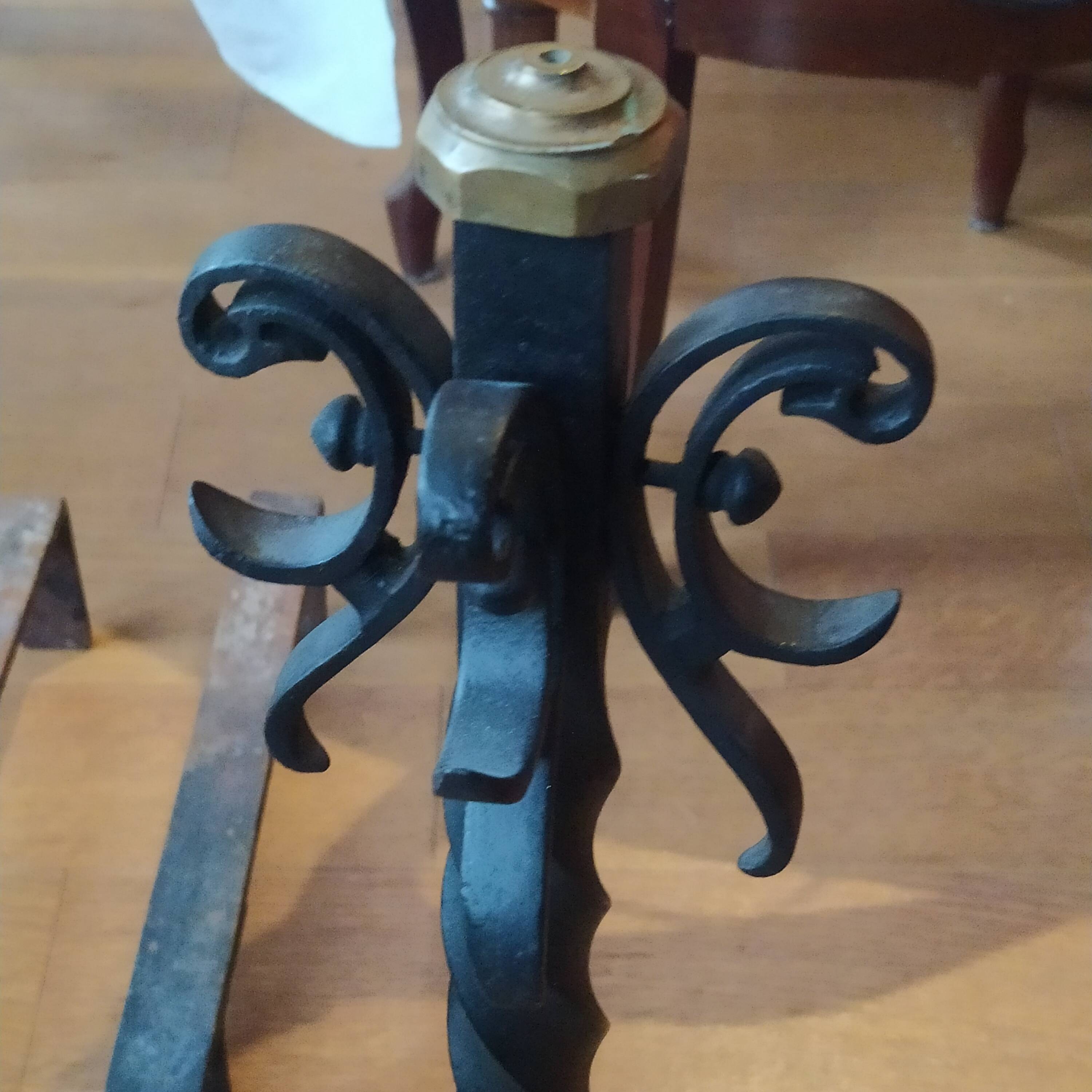 pair of large 20th century metal andirons with mascaron decoration