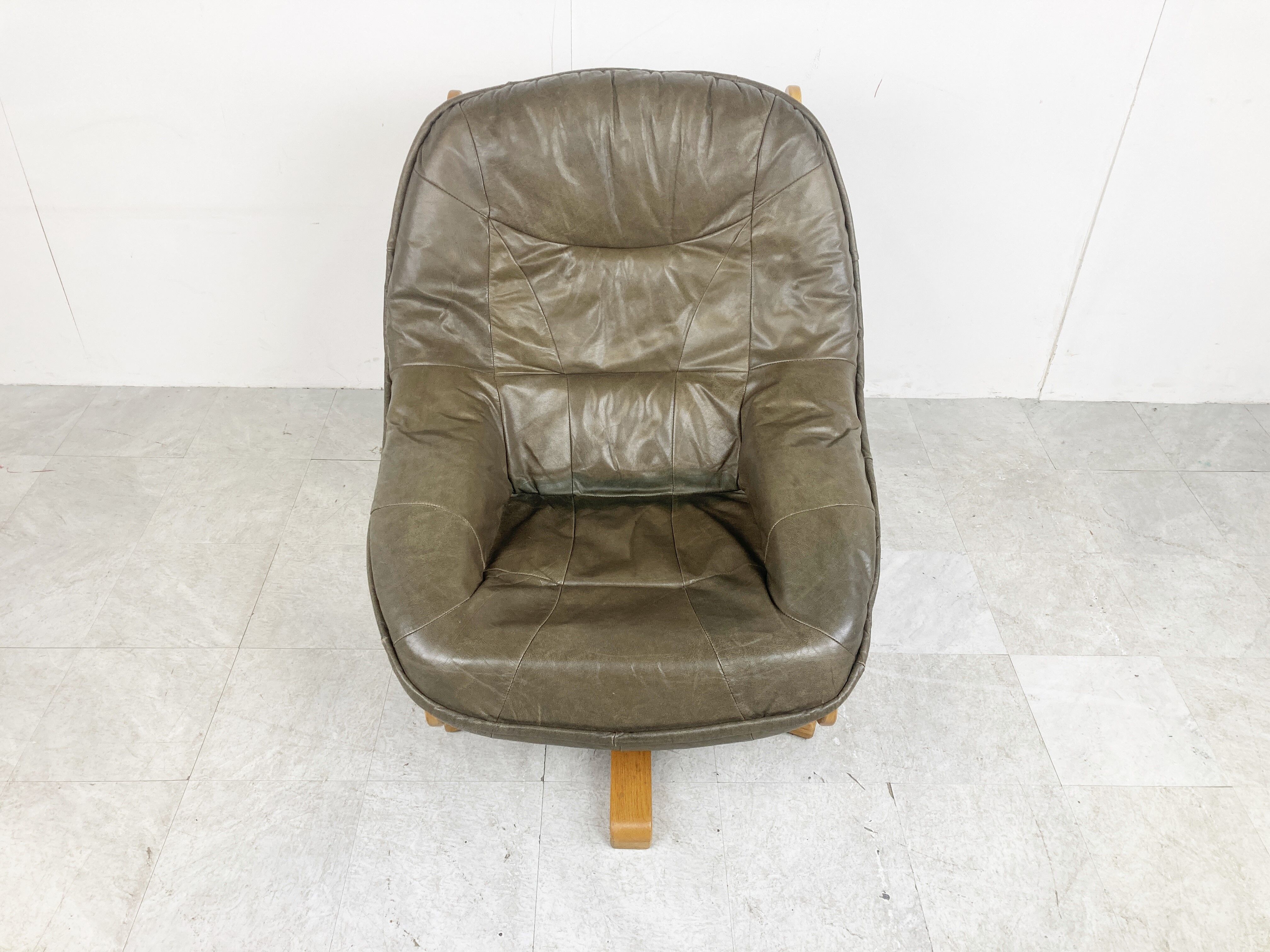 Brutalist oak and leather swivel chair, 1970s