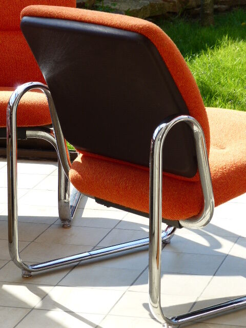 The 1970s orange armchair fabric and chrome metal