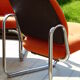 The 1970s orange armchair fabric and chrome metal