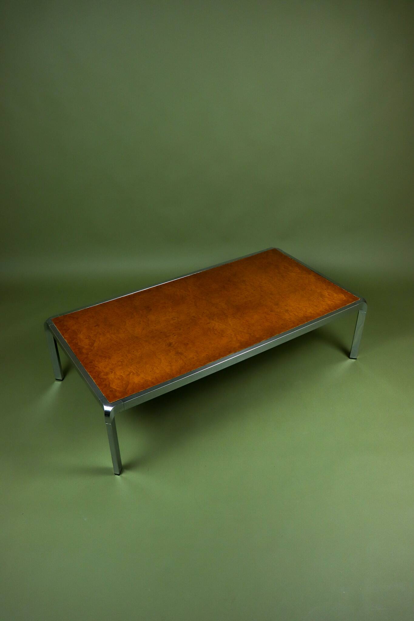Vintage 1970s coffee table in chrome and burl wood.