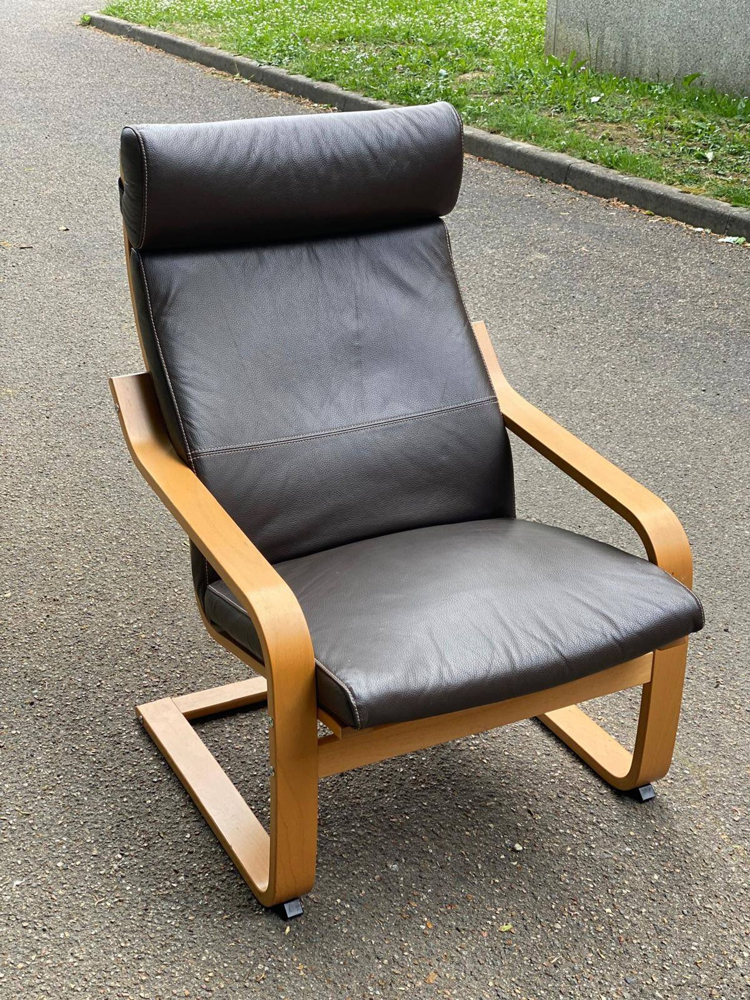 Scandinavian rocking chair in curved wood and brown leather from IKEA Poang