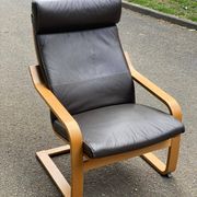 Scandinavian rocking chair in curved wood and brown leather from IKEA Poang