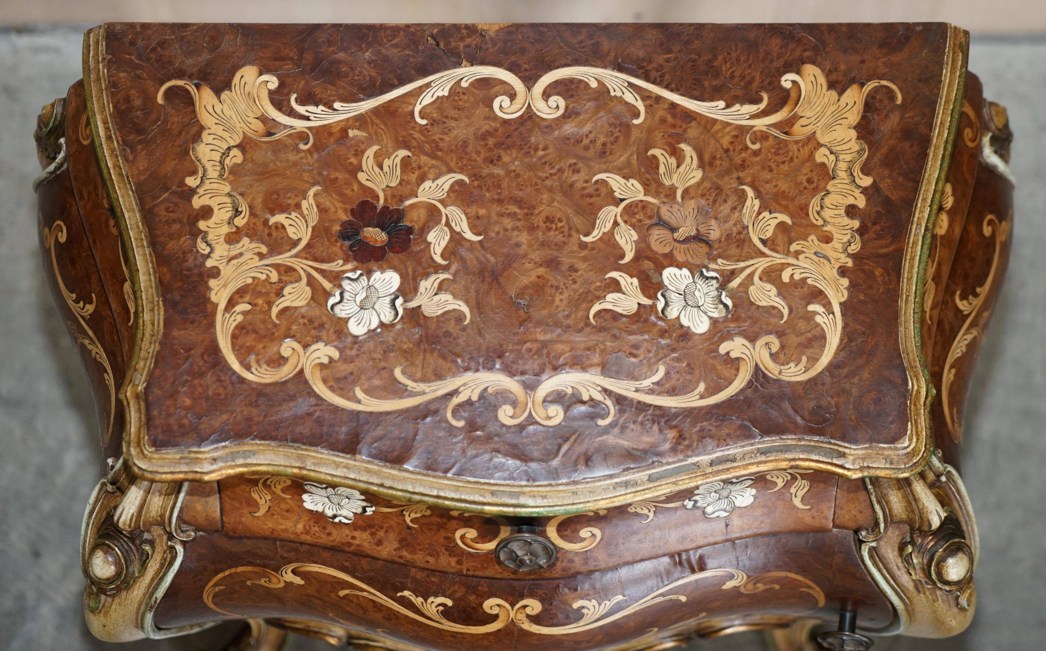 Pair of curved walnut commodes with marquetry and marble tops.