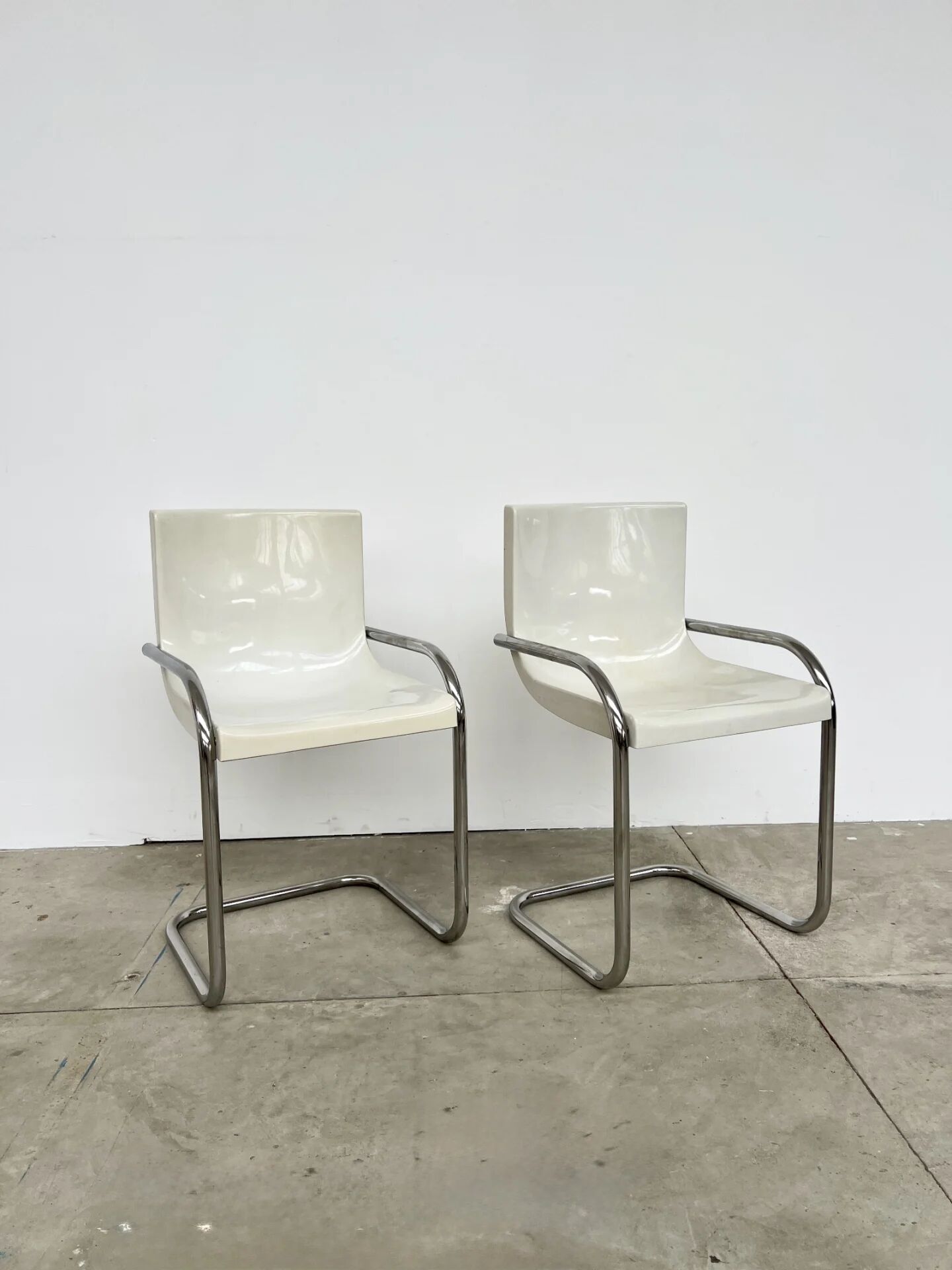 Pair of white moulded shell chairs with chrome tube — Space Age 70s