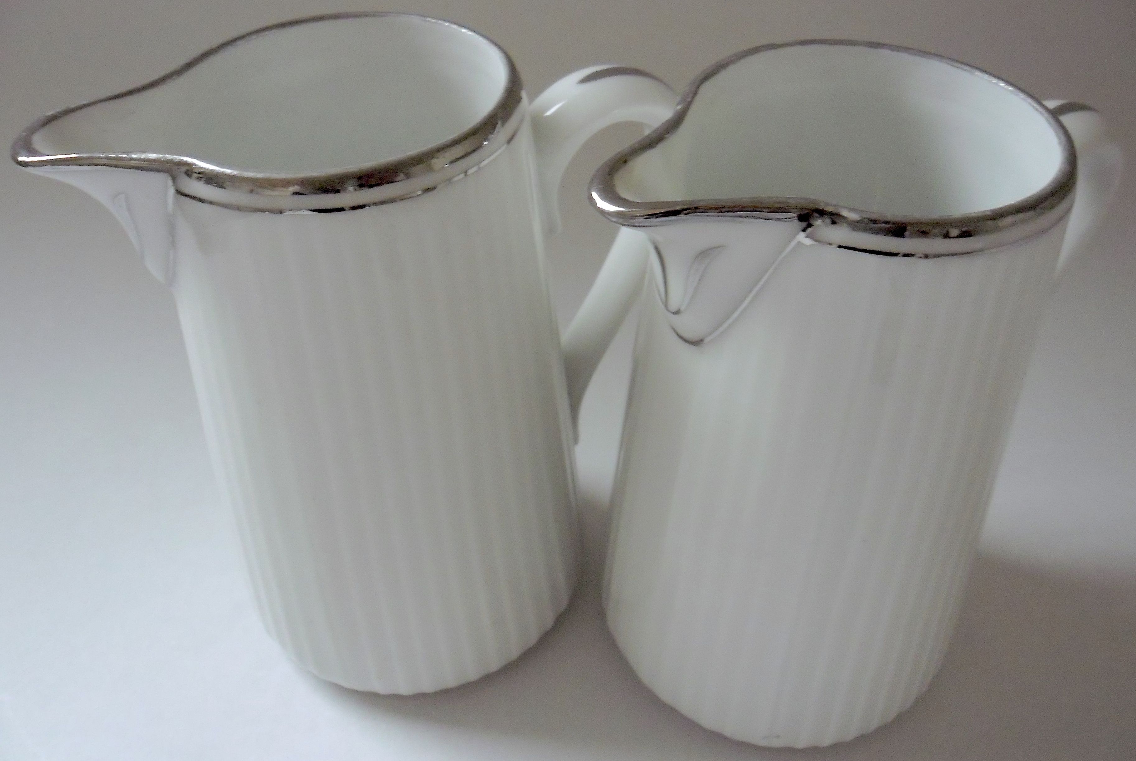 Pair of creamers in white porcelain enhanced with platinum