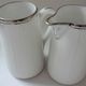 Pair of creamers in white porcelain enhanced with platinum