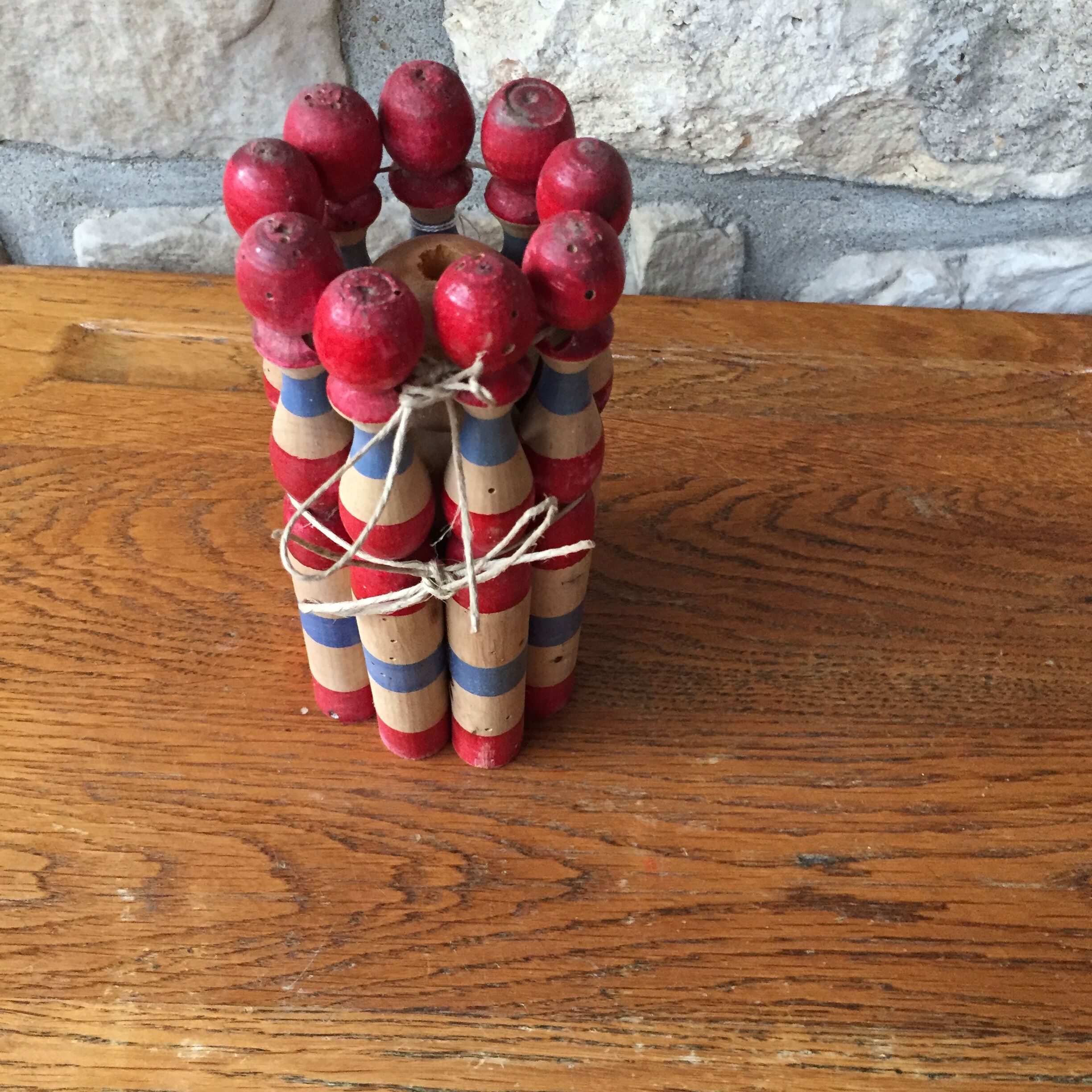 Former wooden tricolor bowling game with its ball